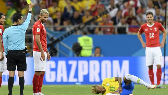 Switzerland&#039;s midfielder Valon Behrami, second left, reacts next to Brazil&#039;s forward Neymar, right, as Referee Cesar Ramos, left, gives a yellow card during the FIFA soccer World Cup 2018 gr ...