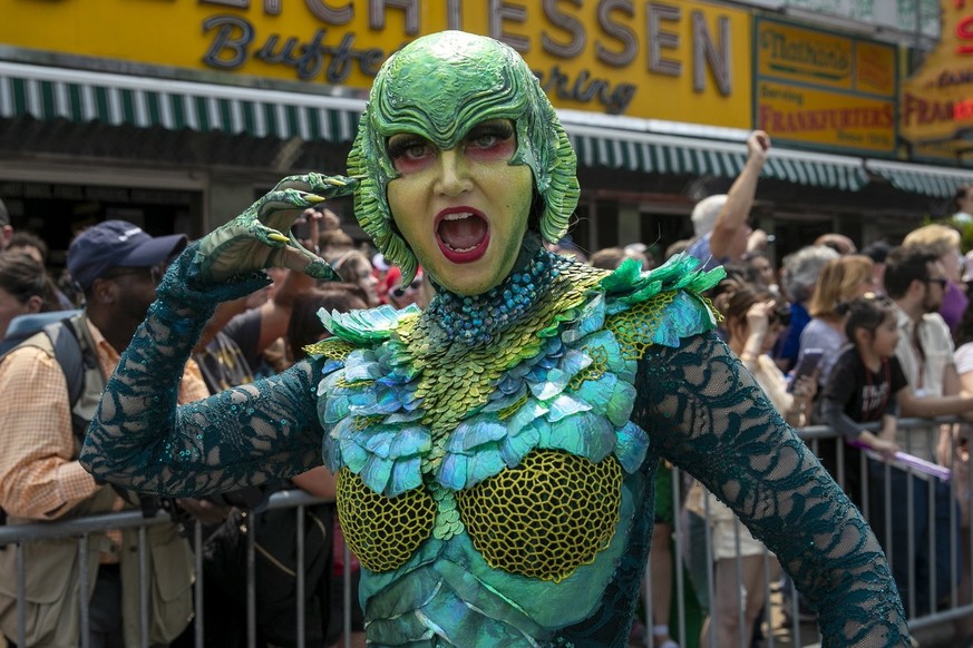 Revelers march during the Mermaid Parade in the Coney Island section of the Brooklyn borough of New York, Saturday, June 17, 2023. (AP Photo/Andres Kudacki)