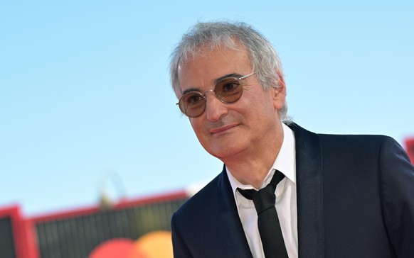 epa12340349 French director Olivier Assayas arrives for the screening of 'Le Mage du Kremlin (The Wizard of the Kremlin)' during the 82nd annual Venice International Film Festival, in Venice ...