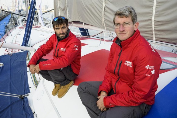 Skippers, Alan Roura of Switzerland, left, and Frederic Denis of France, right, from &quot;La Fabrique&quot; monohull Imoca pose during the 13th Transat Jacques Vabre race in Le Havre, France, Friday, ...