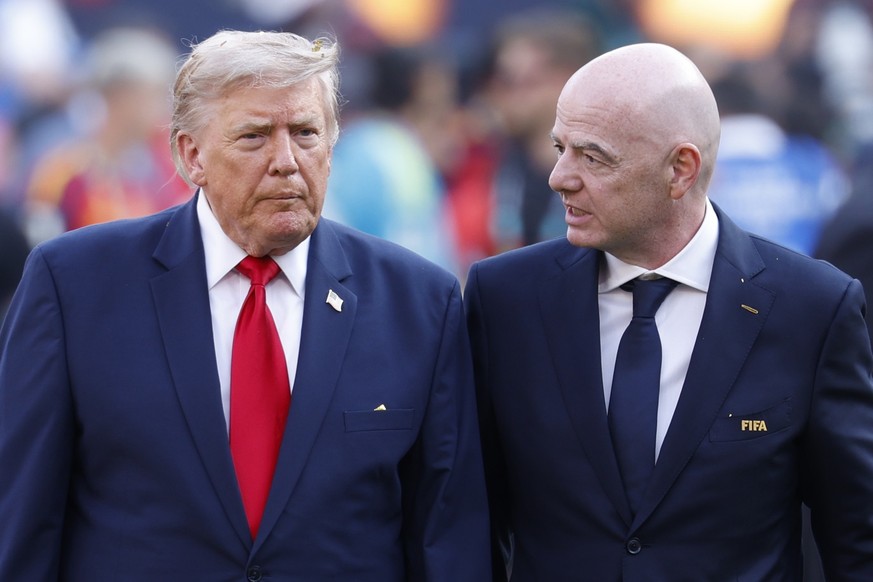 epa13121818 US president Donald Trump (L) and FIFA President Gianni Infantino (R) leave the field after the victory ceremony of the FIFA World Cup 2026 final match Spain against Argentina, in New Jers ...
