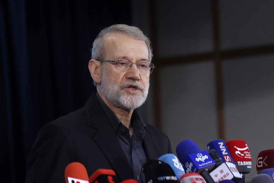 FILE - Former Iran's parliament speaker Ali Larijani speaks with media after registering his name as a candidate for the June 28 presidential elections at the Interior Ministry in Tehran, Iran, M ...