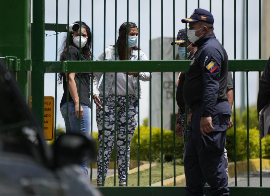 Margareth Baduel, center, the daughter of late Defense Minister Raul Isaias Baduel, speaks to National Police at the entrance to Eastern Cemetery in Caracas, Venezuela, Wednesday, Oct. 13, 2021. The g ...