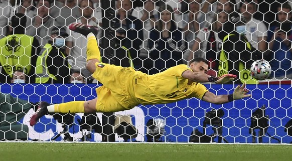 Italy&#039;s goalkeeper Gianluigi Donnarumma makes a save against England&#039;s Jadon Sancho during penalty shootout of the Euro 2020 soccer championship final match between England and Italy at Wemb ...