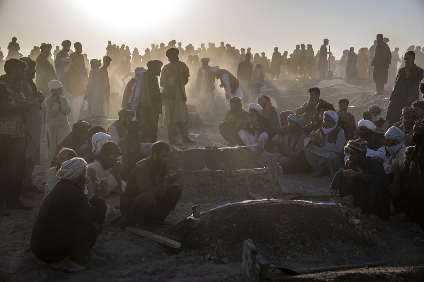 Afghans bury hundreds of people killed in an earthquake to a burial site, in a village in Zenda Jan district in Herat province, western of Afghanistan, Monday, Oct. 9, 2023. Saturday&#039;s deadly ear ...