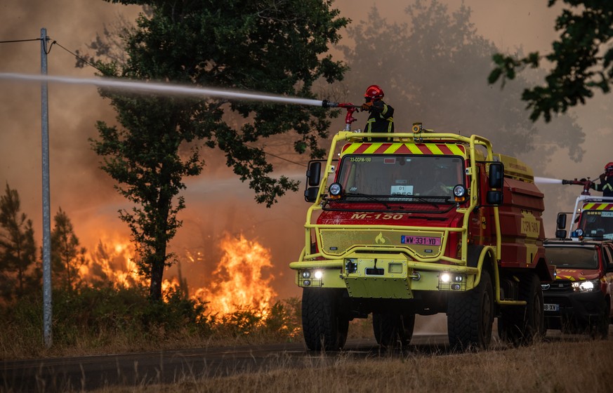 epa13131553 A handout photo made available by SDIS33 (Gironde Departmental Fire and Rescue Service) shows a firefighting crew being deployed to battle a wildfire spreading in Lege-Cap-Ferret, south-we ...