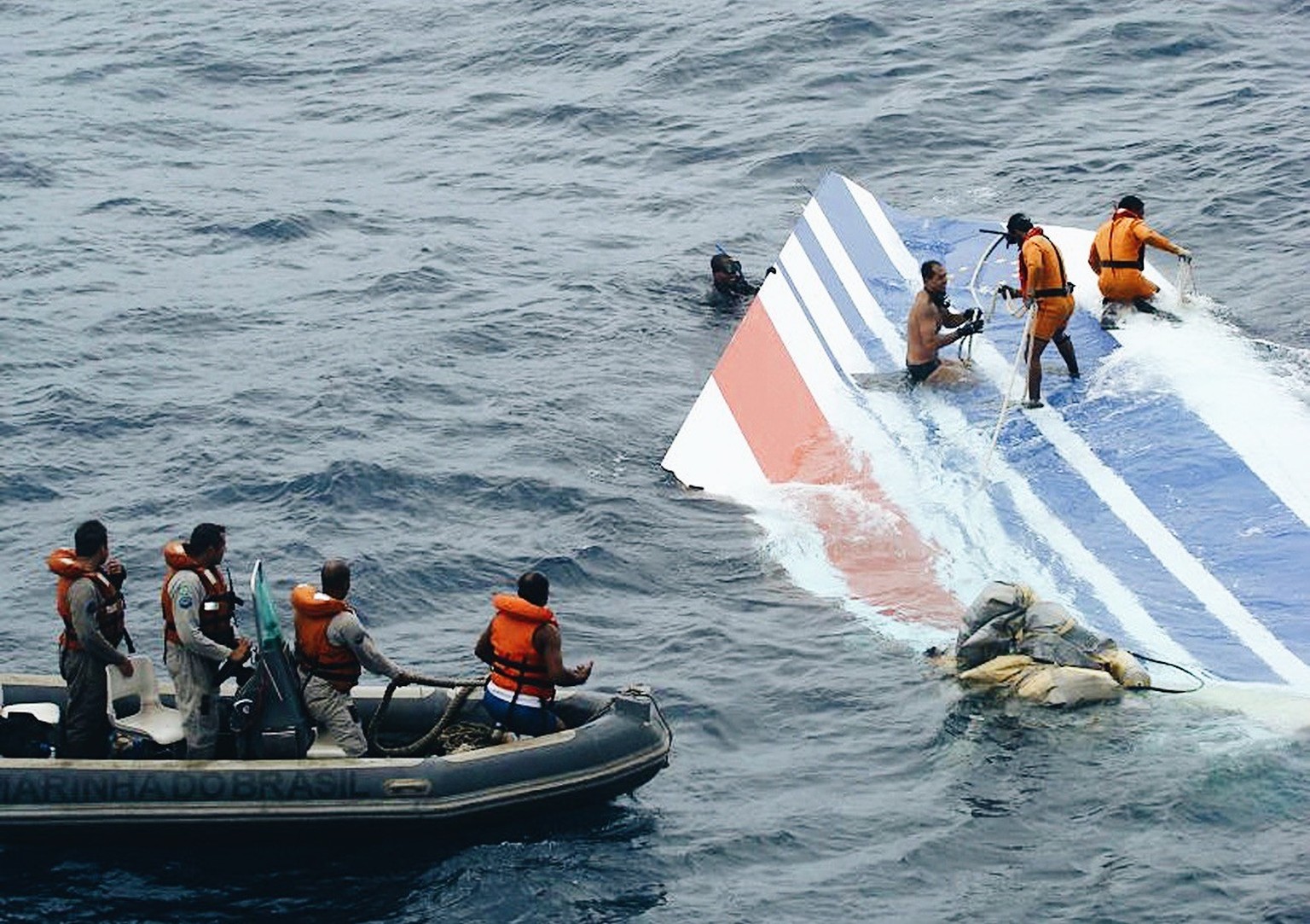 FILE - This Monday, June 8, 2009 file photo released by Brazil&#039;s Air Force shows Brazil&#039;s Navy sailors recovering debris from the missing Air France jet at the Atlantic Ocean. Officials say  ...