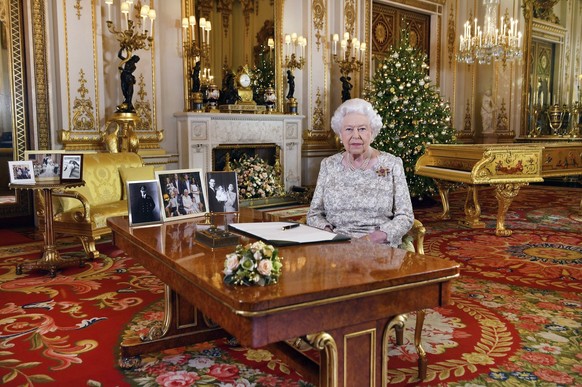 In this image released on Tuesday, Dec. 25, 2018, Britain&#039;s Queen Elizabeth poses for a photograph after she recorded her annual Christmas Day message, in the White Drawing Room of Buckingham Pal ...