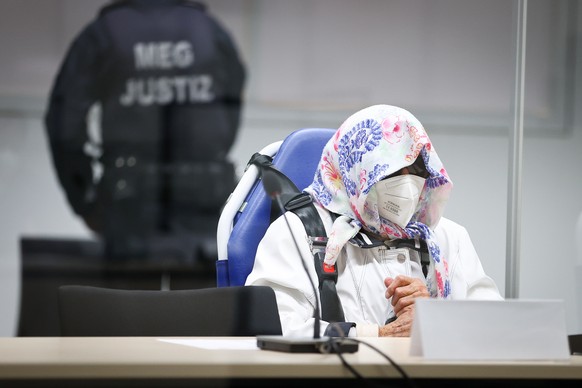 epa09531708 The 96-year-old defendant Irmgard F. sits in an ambulance chair behind a plexiglass screen in the courtroom during her trial at the REgional Court in Itzehoe, Germany, 19 October 2021. In  ...