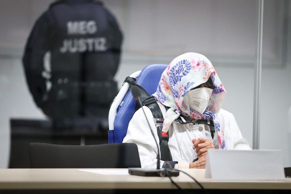epa09531708 The 96-year-old defendant Irmgard F. sits in an ambulance chair behind a plexiglass screen in the courtroom during her trial at the REgional Court in Itzehoe, Germany, 19 October 2021. In ...