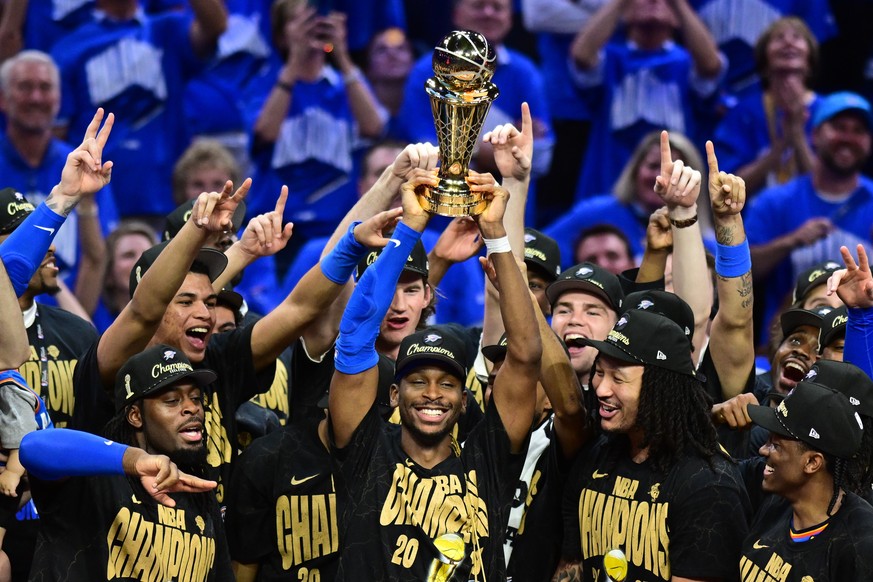 epaselect epa12192040 Oklahoma City Thunder guard Shai Gilgeous-Alexander (C) holds the Bill Russell NBA Finals Most Valuable Player Award following the Oklahoma City Thunder win of the NBA finals, de ...