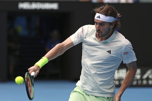 Stefanos Tsitsipas of Greece plays a backhand return to Luca Van Assche of France during their third round match at the Australian Open tennis championships at Melbourne Park, Melbourne, Australia, Fr ...