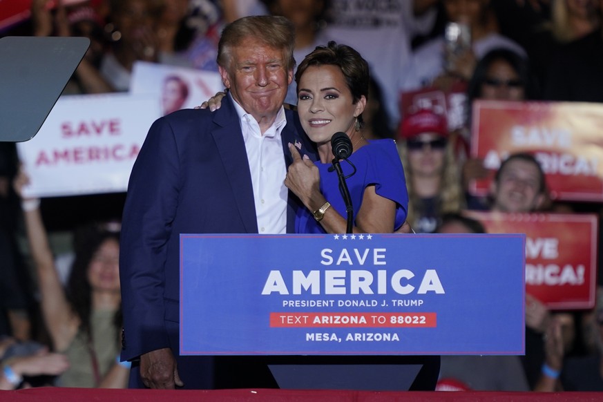 Former President Donald Trump embraces Arizona Republican gubernatorial candidate Kari Lake at a rally, Sunday, Oct. 9, 2022, in Mesa, Ariz. (AP Photo/Matt York)