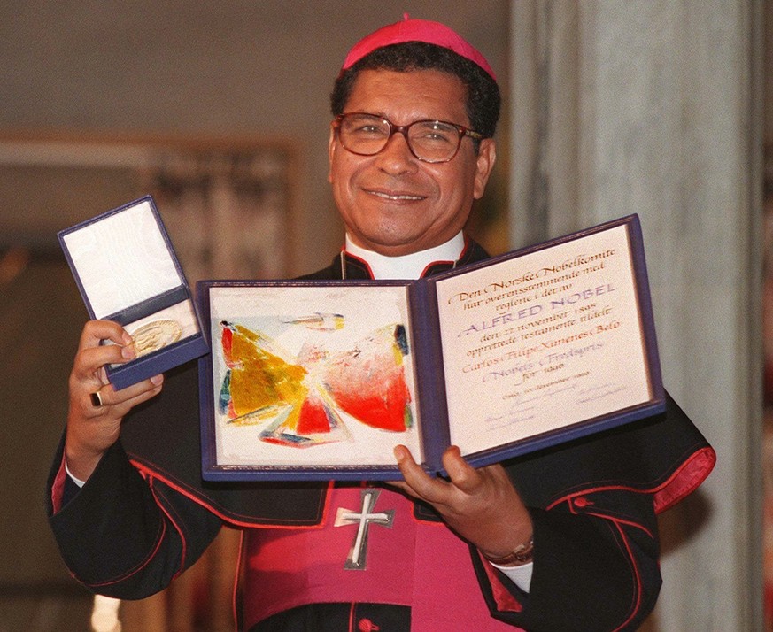 FILE - Nobel Peace Prize laureate, East Timor bishop Carlos Filipe Ximenes Belo displays his certificate and medal during the Nobel ceremony at the Oslo townhall, on Dec. 10, 1996. Belo has been accus ...