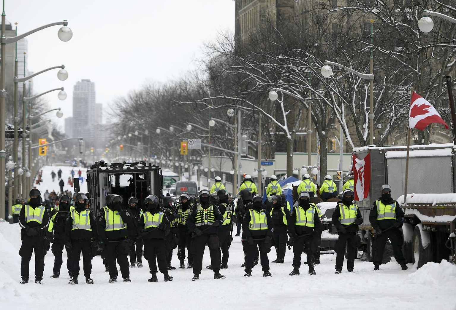 Police form up on Wellington Street as they take action to put an end to a protest in Ottawa, Ontario, Saturday, Feb. 19, 2022. Police resumed pushing back protesters on Saturday after arresting more  ...