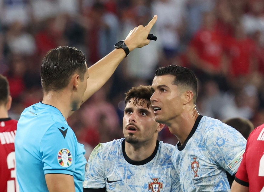 epa11440257 Pedro Neto of Portugal (C) and Cristiano Ronaldo of Portugal react to referee Sandro Schaerer during the UEFA EURO 2024 group F soccer match between Georgia and Portugal, in Gelsenkirchen, ...