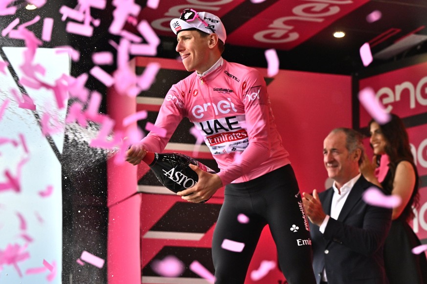 epa11363698 Slovenian rider Tadej Pogacar of Uae Team Emirates retaining the overall leader&#039;s pink jersey celebrates on the podium after the 18th stage of the Giro d&#039;Italia 2024 cycling tour ...