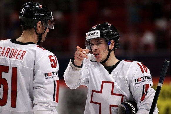 Switzerland&amp;#039;s Raphael Diaz, right, speaks with his teammate Ryan Gardner, left, during the IIHF Ice Hockey World Championships preliminary round game Belarus vs Switzerland at the Globe Arena ...