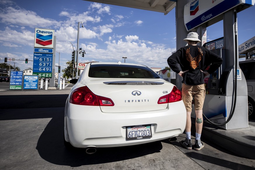 epa10208366 A man refuels his car at a gas station displaying gas prices well above six dollars a gallon in Los Angeles, California, USA, 26 September 2022. Average gas prices in Los Angeles have hit  ...