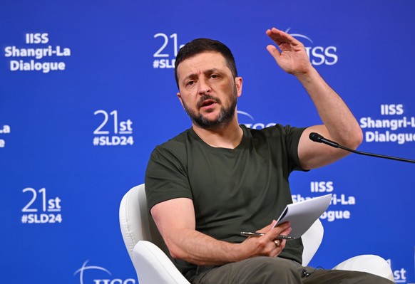 epa11385112 Ukraine&#039;s President Volodymyr Zelensky gestures as he speaks during a press conference on the sideline of the International Institute for Strategic Studies (IISS) 21th Shangri-La Dial ...