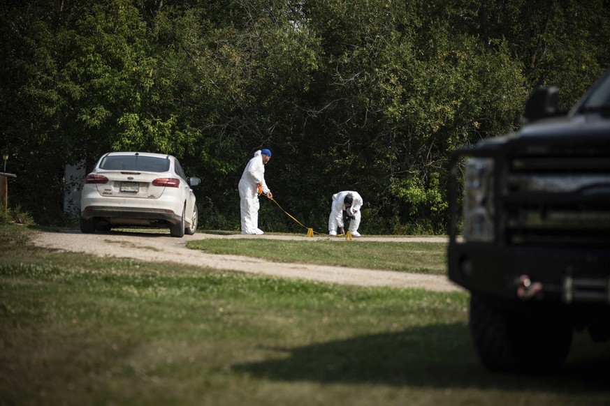 Investigators examine the crime scene outside the home of Wes Petterson in Weldon, Saskatchewan, Monday, Sept. 5, 2022. Petterson, 77, was killed in a series of stabbings in the area on Sunday. (AP Ph ...