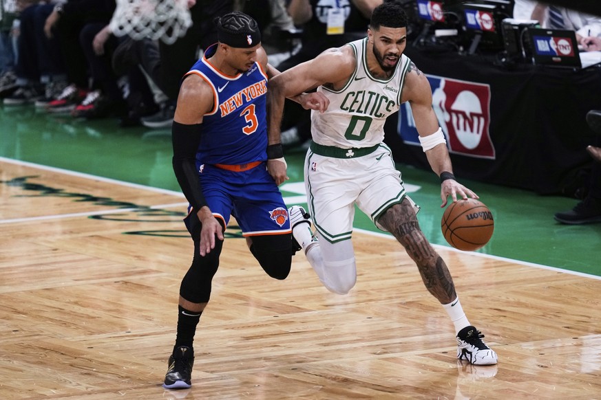 Boston Celtics forward Jayson Tatum (0) drives to the basket against New York Knicks guard Josh Hart (3) during the first half of Game 1 of an NBA basketball second-round playoff series Monday, May 5, ...