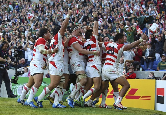 Saturday, Sept. 19, 2015 , Japan players celebrate after Karne Hesketh scored the winning try against South Africa during the Rugby World Cup Pool B match at the Brighton Community Stadium in Brighton ...