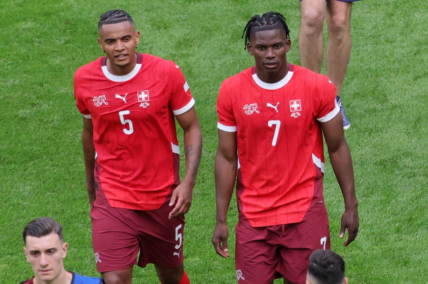 epa11412450 Manuel Akanji (L) and Breel Embolo (R) of Switzerland celebrate after winning the UEFA EURO 2024 group A match between Hungary and Switzerland in Cologne, Germany, 15 June 2024. EPA/OLIVIE ...