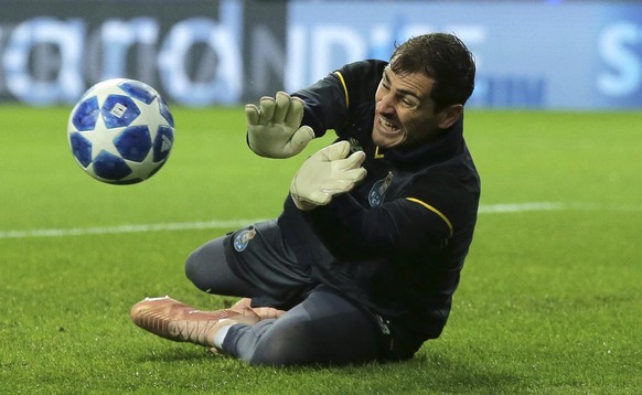 Porto goalkeeper Iker Casillas dives for a save during warmup before the Champions League group D soccer match between FC Porto and Lokomotiv Moscow at the Dragao stadium in Porto, Portugal, Tuesday,  ...