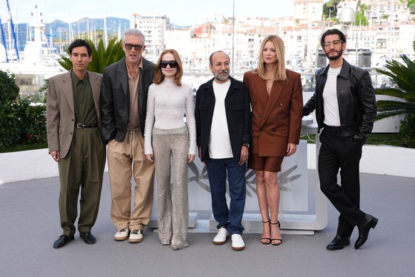 Adam Bessa, from left, Vincent Cassel, Isabelle Huppert, director Asghar Farhadi, Virginie Efira and Pierre Niney pose for photographers at the photo call for the film 'Parallel Tales' durin ...