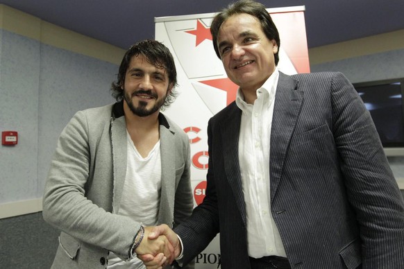 New FC Sion soccer player Italian midfielder Gennaro Gattuso, left, shakes hands with the FC Sion president Christian Constantin, right, before a training session of the Swiss Super League, first divi ...