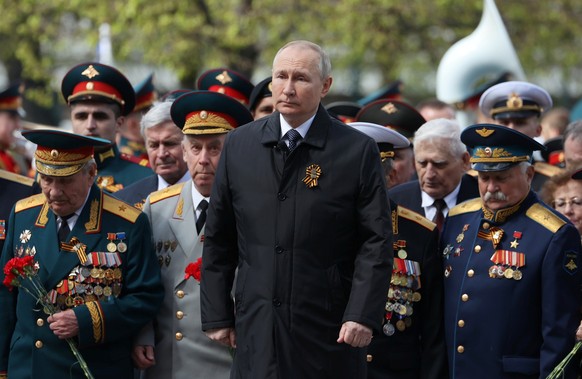 Russian President Vladimir Putin, centre, attends a wreath-laying ceremony at the Tomb of the Unknown Soldier after the military parade marking the 77th anniversary of the end of World War II, in Mosc ...