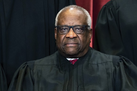 FILE - Justice Clarence Thomas sits during a group photo at the Supreme Court in Washington, on Friday, April 23, 2021. Thomas has been hospitalized because of an infection, the Supreme Court said Sun ...