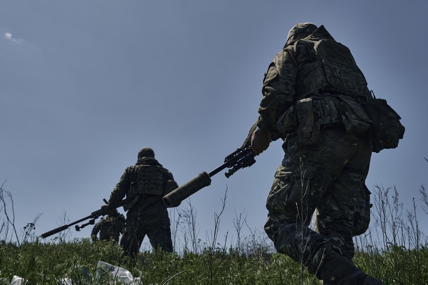 Ukrainian army snipers change their position facing Russian troops near Bakhmut, Donetsk region, Ukraine, Tuesday, May 2, 2023. (AP Photo/Libkos)