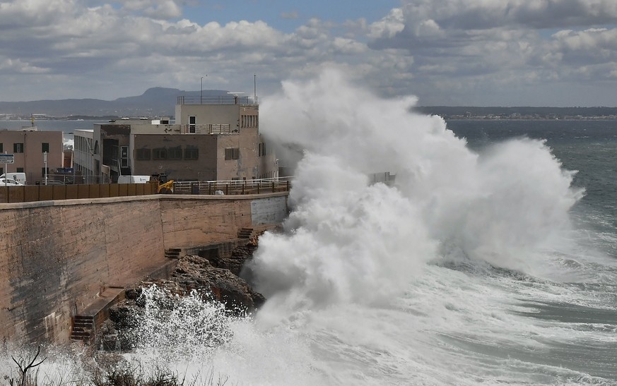epa11246746 Waves hit the west dock and the sailing school at the port in Palma de Mallorca, Majorca island, eastern Spain, 27 March 2024. Storm Nelson is forecast to affect Spain during the Holy Week ...
