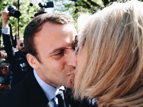 French centrist presidential election candidate Emmanuel Macron kisses his wife Brigitte Trogneux during a campaign visit in Bagneres-de-Bigorre, southwestern France, Wednesday, April 12, 2017. The tw ...