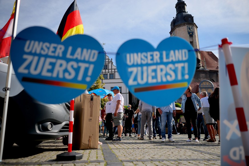 epa13189419 Supporters await a campaign event by Ulrich Siegmund, lead candidate of the far-right Alternative for Germany (AfD), prior to state elections in Saxony-Anhalt, in Naumburg, Germany, 24 Aug ...