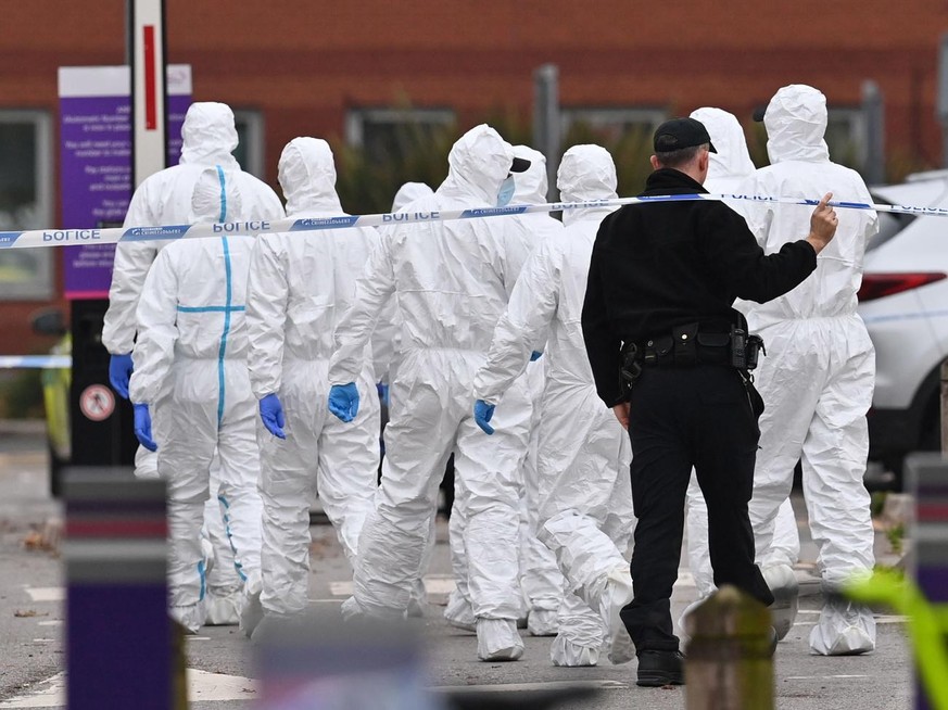 epa09583475 Police officers work inside a cordon by Rutland Avenue in Liverpool, Britain, 15 November 2021. British police announced the arrest of three men under the Terrorism Act after a car explode ...