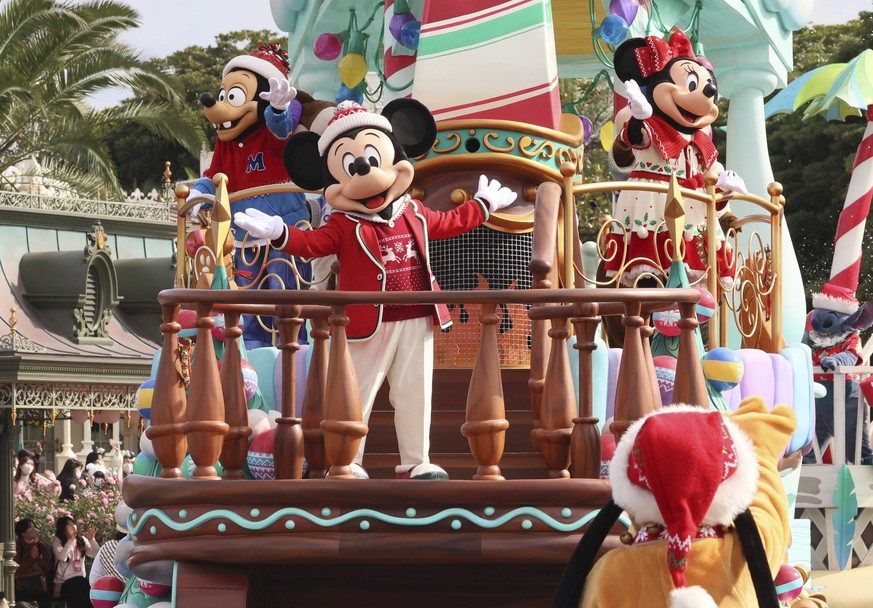 Disney characters Mickey and Minnie Mouse perform on a float for a Christmas parade at a press preview at the Tokyo Disneyland in Urayasu, suburban Tokyo Monday, Nov. 7, 2022. Special Disney character ...