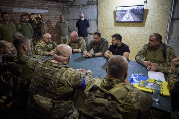 epa10840754 A handout picture made available by the presidential press service shows Ukrainian President Volodymyr Zelensky (C-R) meet with servicemen during his working visit to the Donetsk region, U ...