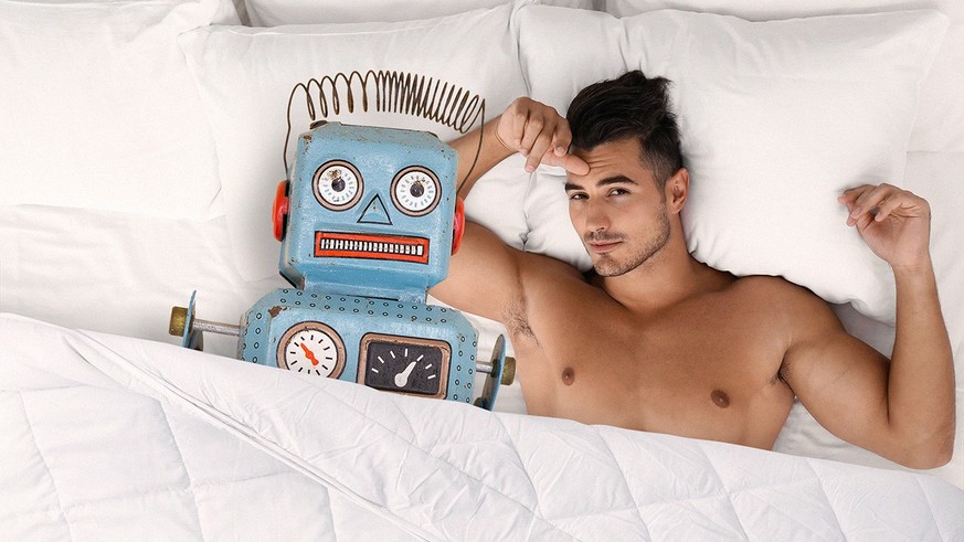 Sexy young man lying on bed with soft pillows at home, top view