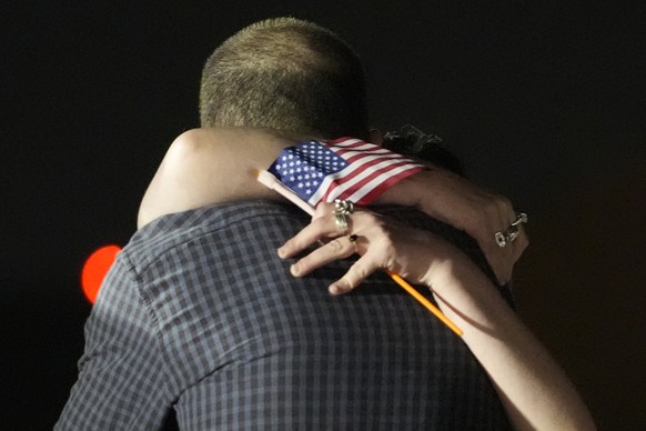 Reporter Evan Gershkovich, in foreground, hugs his sister Danielle Gershkovich at Andrews Air Force Base, Md., following his release as part of a 24-person prisoner swap between Russia and the United  ...