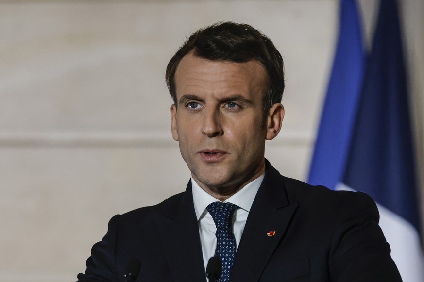 epa09036724 French President Emmanuel Macron delivers a press conference after a European Council summit held over video-conference, at the Elysee Palace in Paris, France, 25 February 2021. The 27 EU  ...