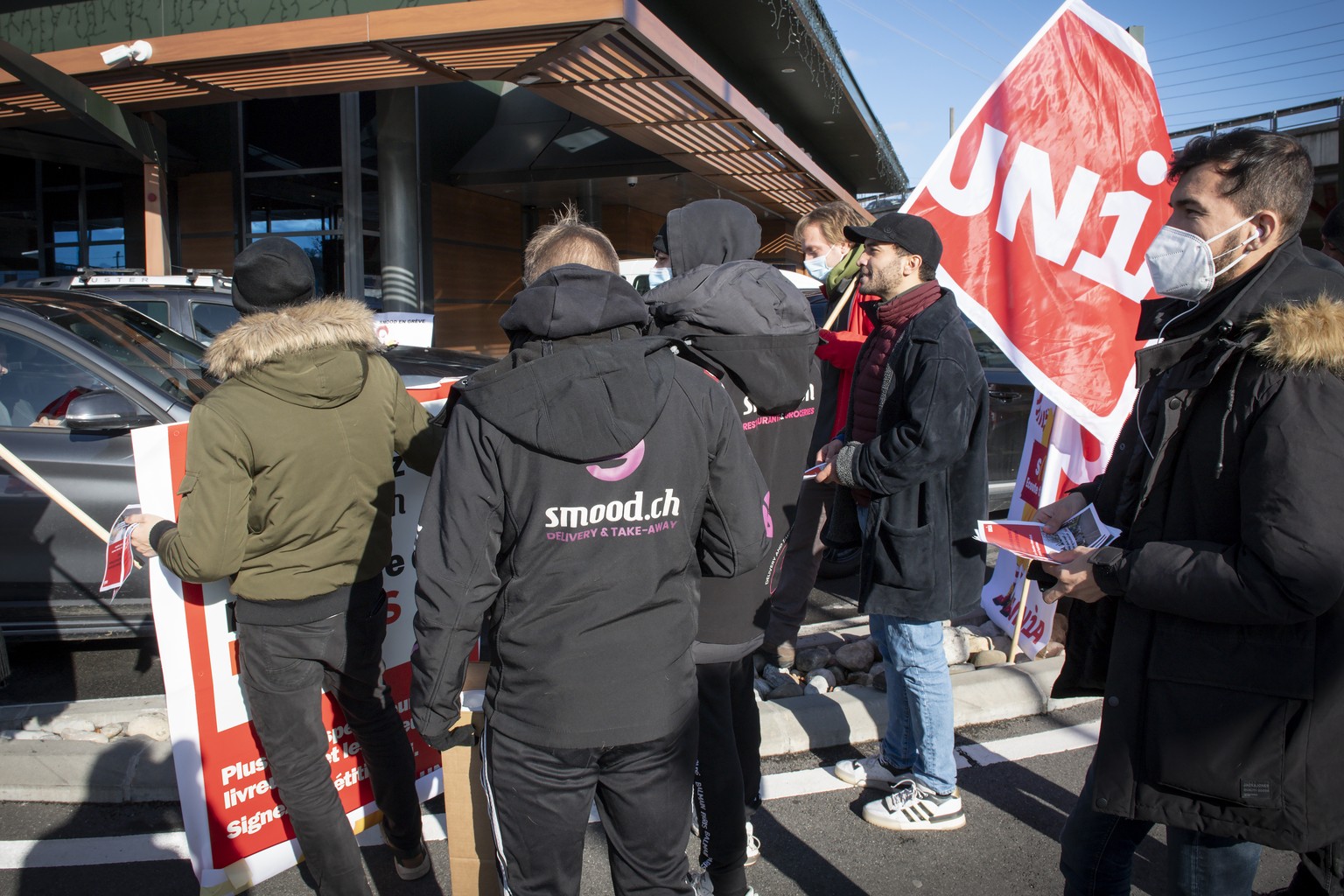 Un groupe de livreurs grevistes de l'entreprise Smood et des militants d Unia manifestent devant le siege de Mc Donald a midi ce vendredi 3 decembre 2021 a Crissier. Ils ont brievement gene la fl ...