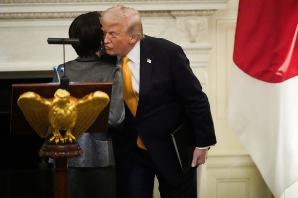 President Donald Trump greets Japan's Prime Minister Sanae Takaichi during a dinner in the State Dining Room of the White House, Thursday, March 19, 2026, in Washington. (AP Photo/Julia Demaree N ...