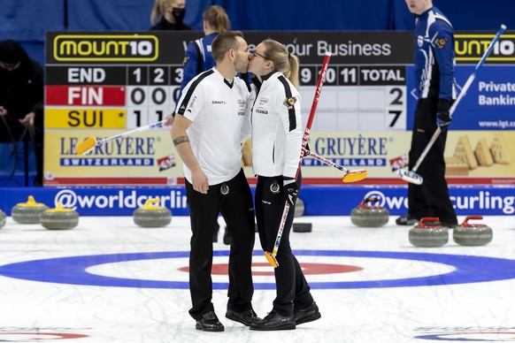 Switzerland team Sven Michel kisses Alina Paetz after defeating Finland team, during the Round Robin game between Finland and Switzerland at the World Mixed Doubles Curling Championship 2022, at the S ...