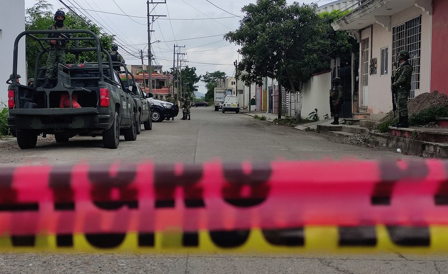 epa10800223 Mexican Army troops guard the area where several dismembered bodies were found in the municipality of Poza Rica, Veracruz state, Mexico, 14 August 2023. Mexican authorities reported the di ...