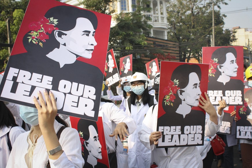 FILE - Medicals students display images of deposed Myanmar leader Aung San Suu Kyi during a street march in Yangon, Myanmar, on Feb. 28, 2021. A Myanmar court convicted Suu Kyi in more corruption case ...