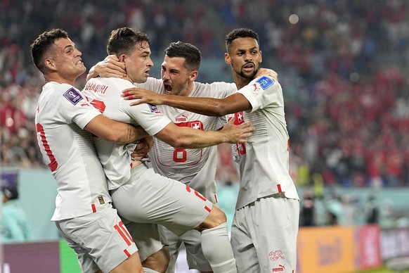 Switzerland's Xherdan Shaqiri, second left, celebrates with teammates after scoring his side's opening goal during the World Cup group G soccer match between Serbia and Switzerland, at the S ...