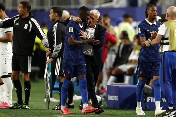 epa13057571 Ousmane Dembele of France (L) talks with his head coach Didier Deschamps as he leaves the pitch during the FIFA World Cup 2026 group stage match France against Iraq, in Philadelphia, Penns ...